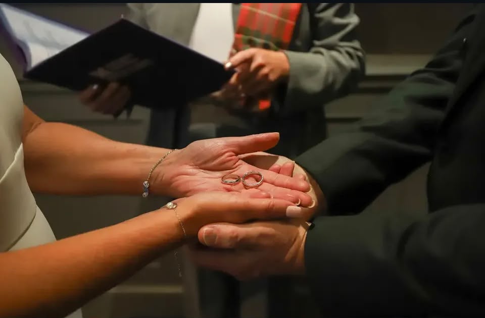 A couple exchanging rings during their ceremony